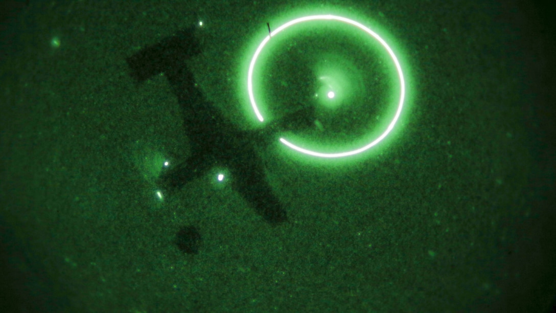 An MV-22B Osprey, operated by a crew with Marine Medium Tiltrotor Training Squadron 204, carries cargo during a night time external lifts operation at Marine Corps Base Camp Lejeune, N.C., Dec. 14, 2015. Marines with 2nd TSB supported the exercise to facilitate the required flight hours for student pilots, and practice their own skills as a helicopter support team securing transportation of resources for Marines that would need it in a real-world operation. 