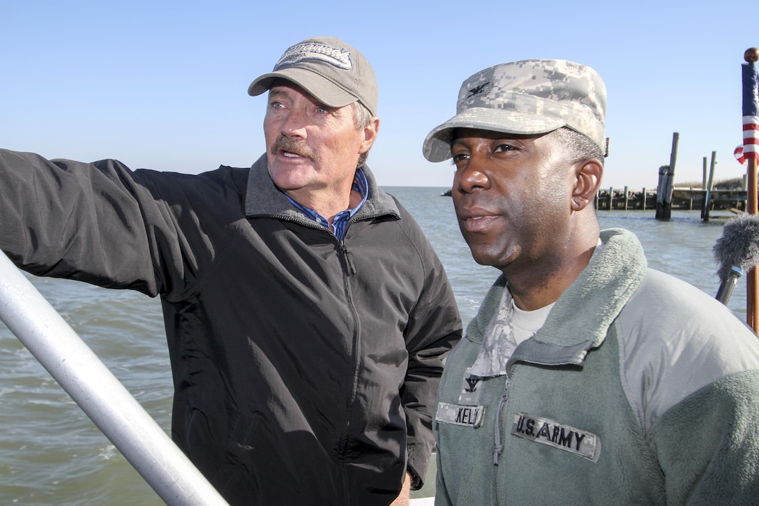 James "Ooker" Eskridge (left), mayor of the town of Tangier, gives Col. Jason Kelly, commander of the Norfolk District, a boat tour around Tangier Island, on December 4. Kelly came to brief the town of a little more than 700 people on the status of district projects around their island. (U.S. Army photo/Patrick Bloodgood)