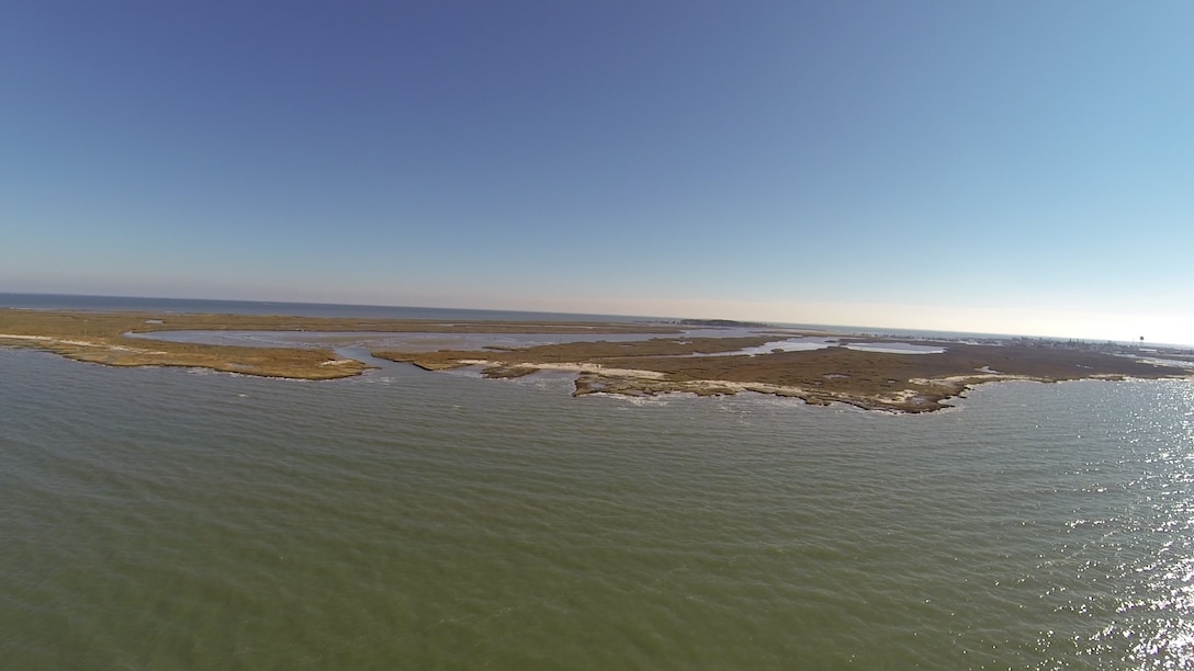 TANGIER, Va. – Aerial imagery of the Uppards portion of Tangier Island shows a breach where waters from the Chesapeake Bay flow into interior portions of the land. Each time a dredging occurs the Norfolk District, U.S. Army Corps of Engineers, uses dredged material gathered from the navigation channel at the island to help plug the breach.  (U.S. Army photo/Patrick Bloodgood)