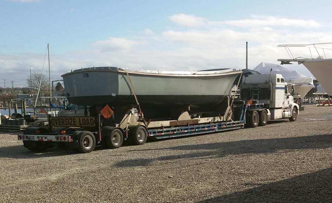 A former Navy utility boat arrives in New London, Connecticut, via tractor-trailer Nov. 30. Two surplus boats will be used to ferry passengers between historical sites along the Thames River as part of the new "Thames River Heritage Park" effort there.