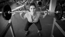 1st Lt. Bobbie-Jean Johnson, 919th Special Operations Wing, squats with two 45-pound weights at the fitness center on Duke Field, Fla. In November 2015, the Air Force Reservist won every division she entered at the Northwest Florida Flex Fest in Pensacola. (U.S. Air Force photo/Tech. Sgt. Jasmin Taylor)