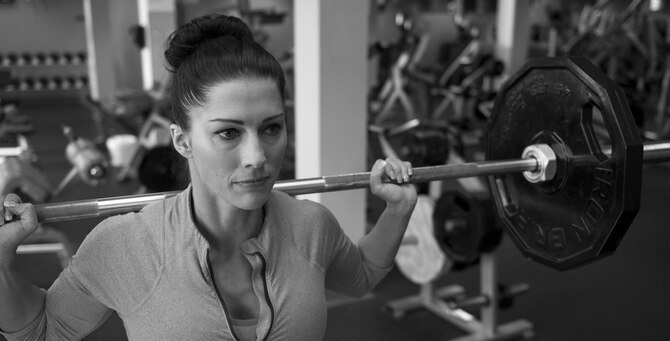 1st Lt. Bobbie-Jean Johnson, 919th Special Operations Wing, squats with two 45-pound weights at the fitness center on Duke Field, Fla. In November 2015, the Air Force Reservist won every division she entered at the Northwest Florida Flex Fest in Pensacola. (U.S. Air Force photo/Tech. Sgt. Jasmin Taylor)