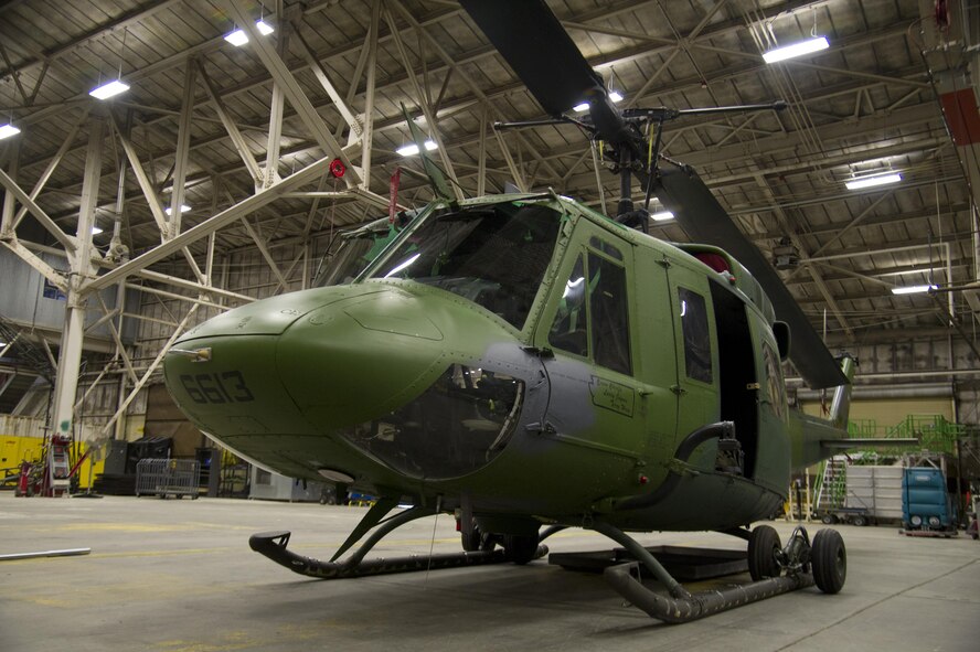 A UH-1N Iroquois helicopter sits in a hangar Nov. 6, 2015, at Fairchild Air Force Base, Wash. The 36th Rescue Squadron’s mission is to provide support for the Survival School. Their support includes: hoist and vector training, parachute operations, upgrade training for Survival, Evasion, Resistance and Escape specialists and the capabilities to perform civilian search and rescue. To date the rescue squadron has 689 saves. (U.S. Air Force photo/Airman 1st Class Nick J. Daniello)