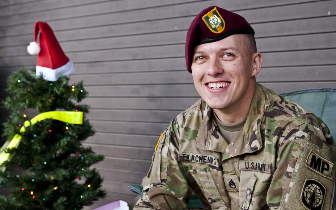 U.S. Army Staff Sgt. Micheal Tkachenko waits in line to donate at the 18th Annual Randy Oler Memorial Operation Toy Drop, hosted by U.S. Army Civil Affairs and Psychological Operations Command, Dec. 3, 2015 at Pope Field, N.C. Operation Toy Drop is the world’s largest combined airborne operation and this year included jumpmasters from seven nations: Canada, Colombia, Germany, Indonesia, Italy, the Netherlands and Latvia. U.S. Army photo by Spc. Angela Lorden