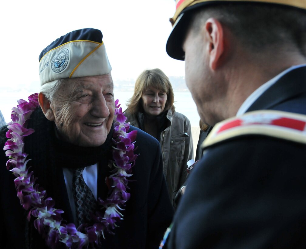 Col. Adam Roth, deputy chief of staff and director of Public Works for the U.S. Army Reserve's 99th Regional Support Command, speaks to a Pearl Harbor survivor following the conclusion of the ceremony Dec. 7 at the USS Intrepid Sea, Air & Space Museum.