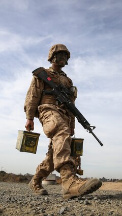 Pfc. Ryan M. Tran, Alpha Company, 1st Recruit Training Battalion, carries ammunition cans during the 12 Stalls event at Edson Range, Weapons and Field Training Battalion, Marine Corps Base Camp Pendleton, Calif., Dec. 9. One rule that was consistent across all challenges was to avoid the areas painted red, which simulated a casualty. The casualties were required to run a marked course with the ammunition cans before they were allowed to rejoin their squad. Today, all males recruited from west of the Mississippi are trained at MCRD San Diego. The depot is responsible for training more than 16,000 recruits annually. Alpha Company will graduate Dec. 18.