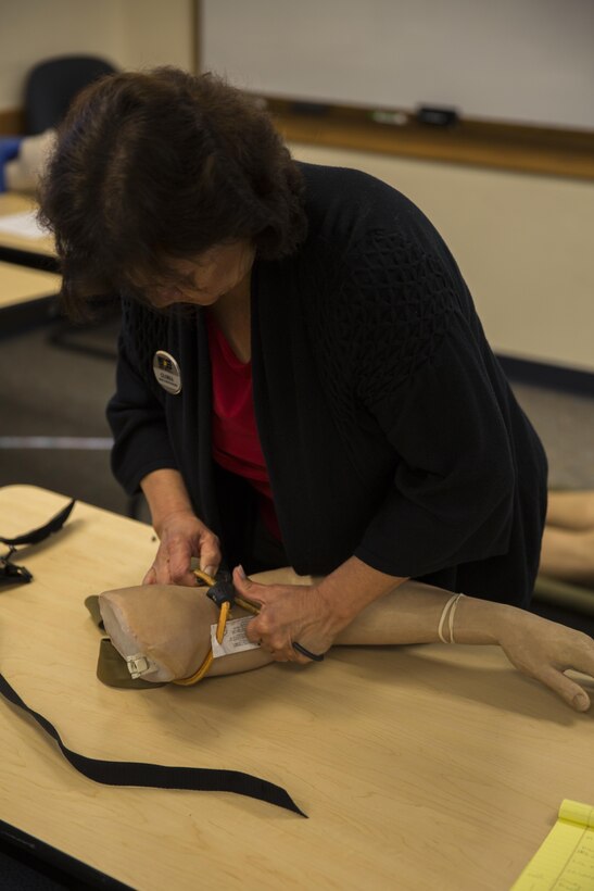 MARINE CORPS BASE CAMP PENDLETON, Calif. – Gloria Federico, an education coordinator with the base Family Advocacy Program and an Oceanside, Calif. native, practices applying an improvised tourniquet during an Improvised Sudden Attack First Emergency Response (IMSAFER) course aboard Marine Corps Base Camp Pendleton, Calif., Dec. 14. Participants in the IMSAFER course completed hands-on training to practice life-saving techniques.