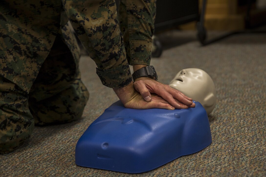MARINE CORPS BASE CAMP PENDLETON, Calif. – Petty Officer 2nd Class Mark Skaggs, an aeromedical safety corpsman with Marine Aircraft Group 39 and a Pensacola, Fla. native, demonstrates proper compression technique for CPR during an Improvised Sudden Attack First Emergency Response (IMSAFER) course aboard Marine Corps Base Camp Pendleton, Calif., Dec. 14. Skaggs also taught students how to use an automated external defibrillator properly during the IMSAFER course.