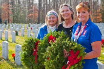 Teri Reece, Blue Star Mothers president, Rhonda Kuebler, Blue Star Mothers member, and Sharon Kendall, Blue Star Mothers member, participate in the annual Wreaths Across America Dec. 12 at Quantico Netional Cemetery in Triangle, Virginia. After seven years, the group continues to support veterans and their families at this annual Wreaths Across America event. In addition to the wreaths, the members raised funds to send approximately 400 care packages to deployed troops overseas during the holidays.