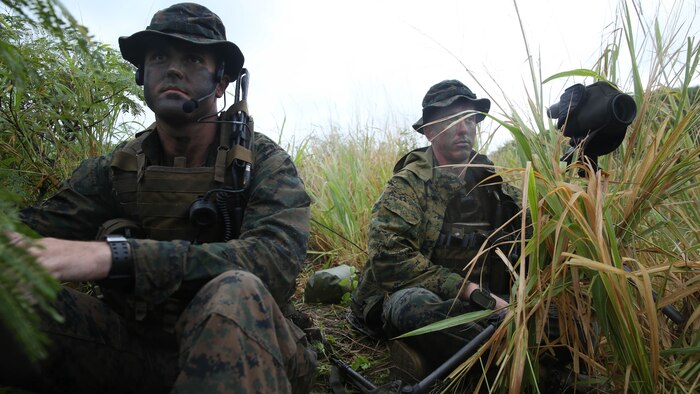 Marines with Company A, 1st Reconnaissance Battalion, 1st Marine Division, survey a named area of interest during reconnaissance and surveillance training, Nov. 19-21, 2015, aboard Marine Corps Training Area Bellows, Hawaii. The Marines conducted insertion, infiltration, execution, exfiltration, and extraction in terrain unfamiliar to what is usually found at their home base in California. The Hawaiian terrain ranged from beach shores, to dense jungle and open valleys during pouring rains