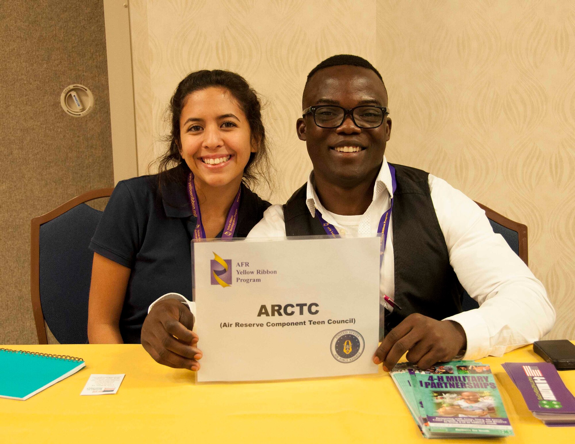 Air Reserve Component Teen Leadership Council members Biannca Recoder and Nathan Williams staff a table to inform guests at a Yellow Ribbon Reintegration event Nov. 20-22 in Orlando. The council is a nationwide group of 14 teens from Air National Guard and Air Force Reserve families. (U.S. Air Force photo by Staff Sgt. Jaimi Upthegrove)