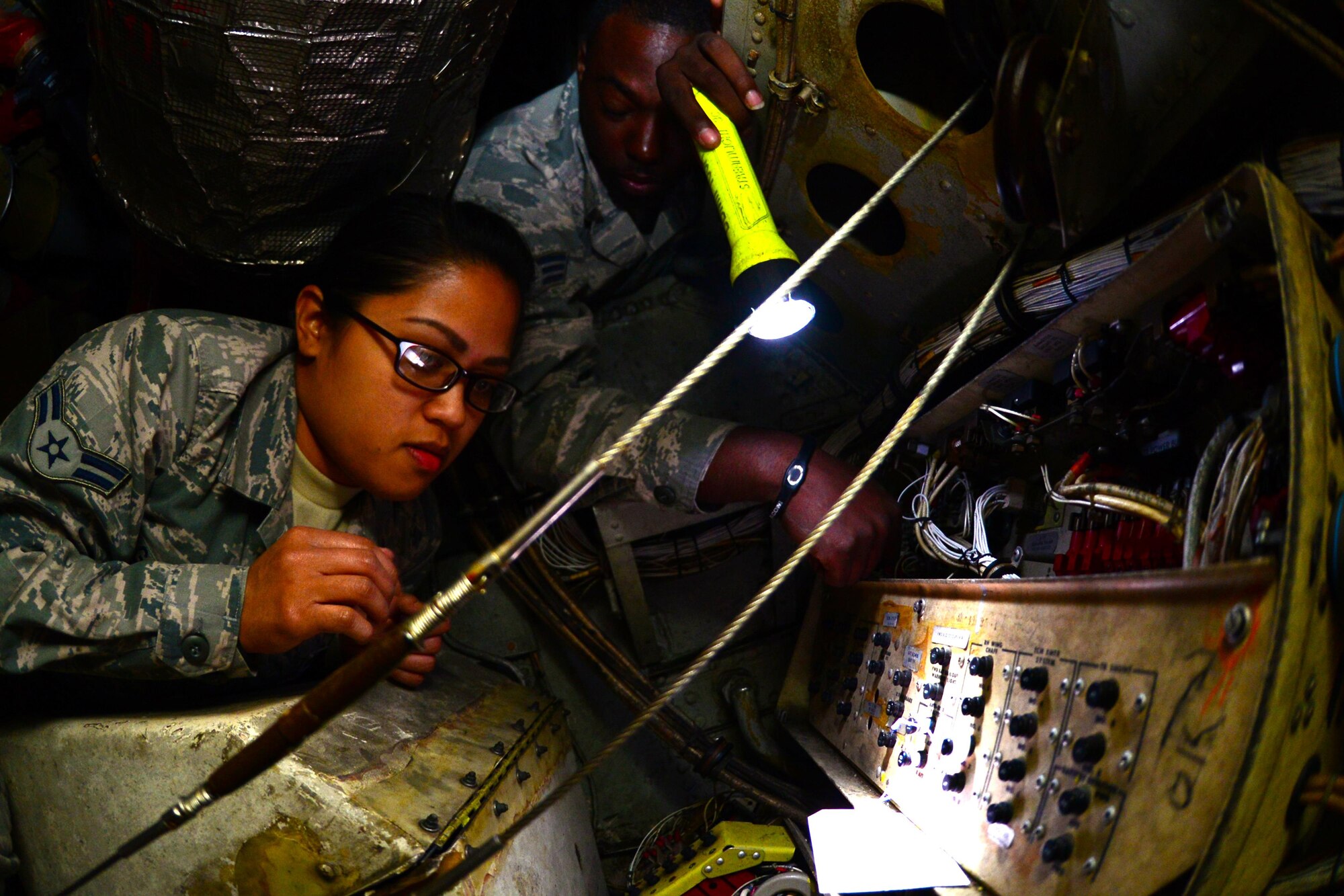 Airman 1st Class Gillan Bagapuro, left, and Senior Airman Michael Fleming, 2nd Maintenance Squadron electrical and environmental technicians, conduct a system check on a power box on a B-52 Stratofortress at Barksdale Air Force Base, La., Dec. 15, 2015. E and E Airmen inspected several different power boxes throughout the day to ensure that all systems were receiving power. (U.S. Air Force Photo/Airman 1st Class Luke Hill) 
