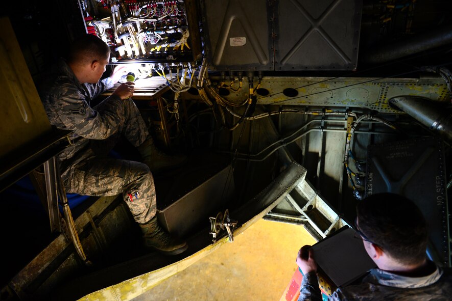 Airmen 1st Class Sean Carnahan, left, and Matthew Gabel, 2nd Maintenance Squadron electrical and environmental technicians, examine electrical systems on a B-52 Stratofortress at Barksdale Air Force Base, La., Dec. 15, 2015. E and E Airmen must have working knowledge and be able to isolate failures in wiring or faulty connections on all Aircraft including helicopters. (U.S. Air Force Photo/Airman 1st Class Luke Hill) 