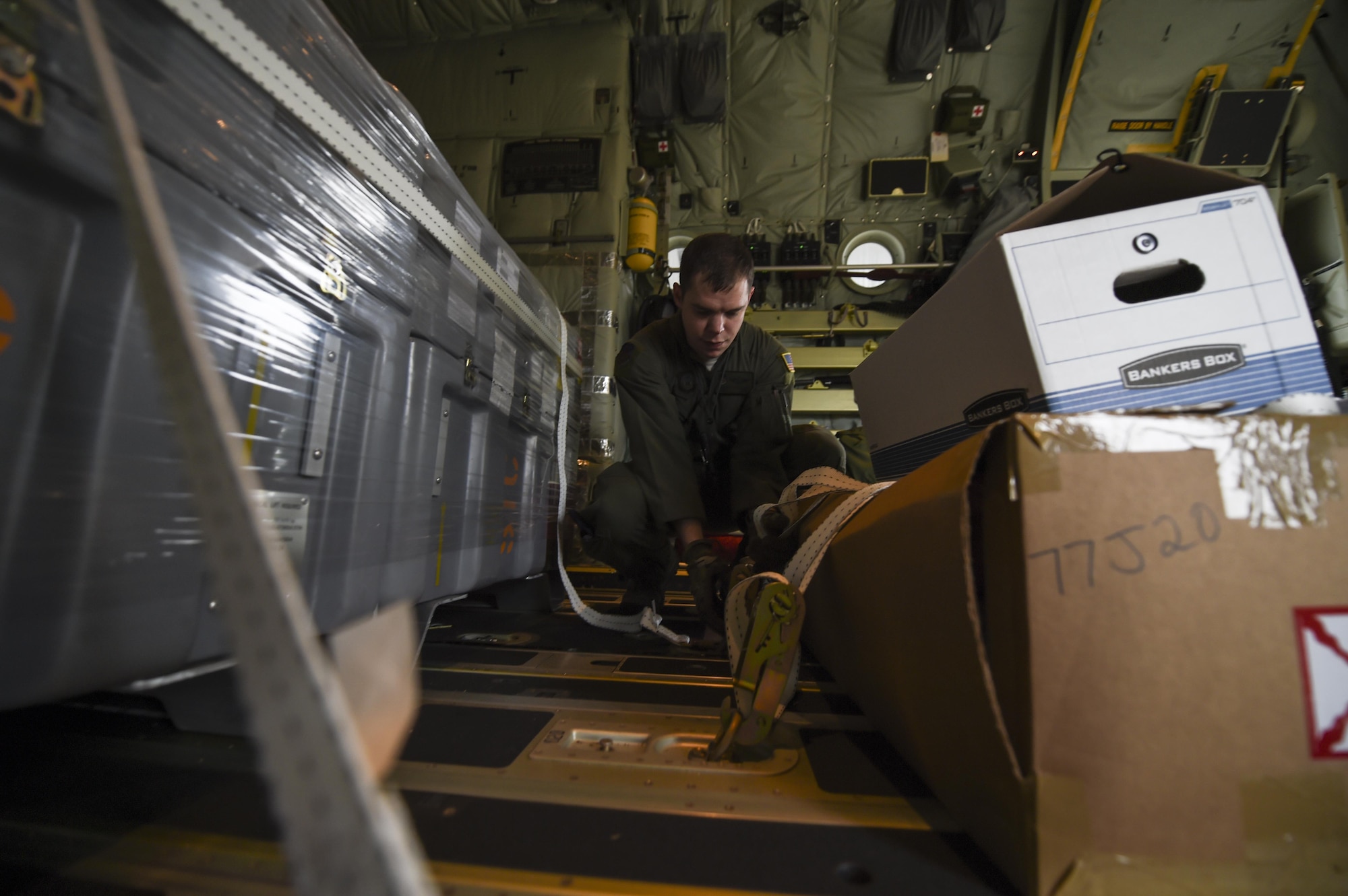 Staff Sgt. Johnny Hooker Jr., a special missions aviator with the 1st Special Operations Group Detachment 2, ties down cargo on an MC-130J Commando II at Lockheed Martin in Marietta, Ga., Dec. 11, 2015. The MC-130J will undergo modifications to become an AC-130J Ghostrider, which will provide the 1 SOW with close air support and air interdiction capabilities. (U.S. Air Force photo by Senior Airman Ryan Conroy)