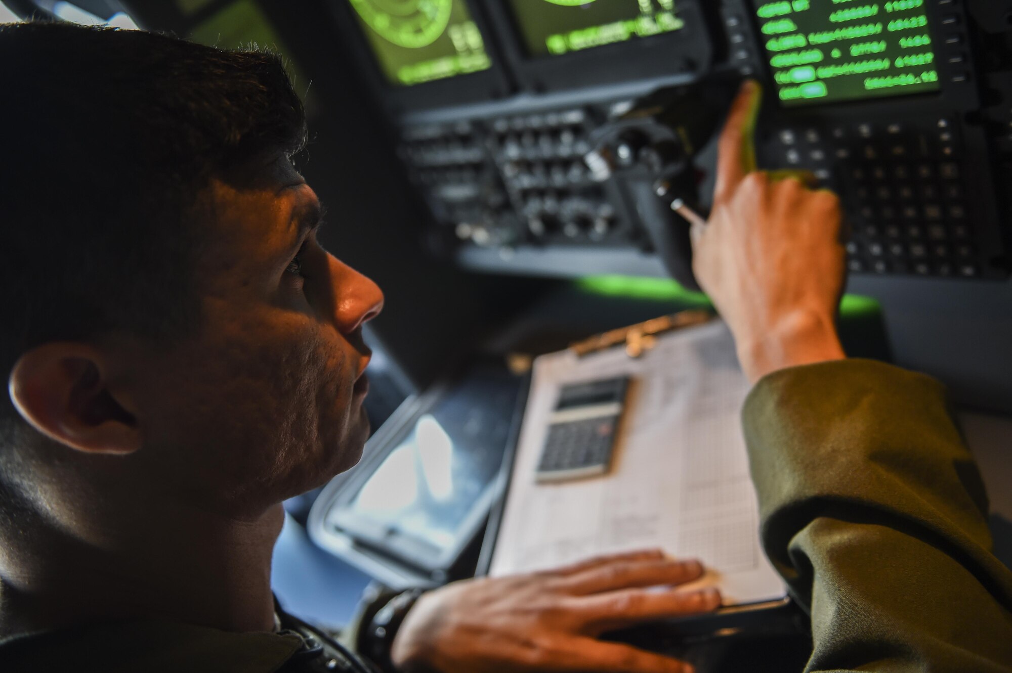Staff Sgt. Oscar Garcia, a special missions aviator with the 1st Special Operations Group Detachment 2, calculates the weight and balance of an MC-130J Commando II during preflight checks at Lockheed Martin in Marietta, Ga., Dec. 11, 2015. The MC-130J will undergo modifications to become an AC-130J Ghostrider, which will provide the 1 SOW with close air support and air interdiction capabilities. (U.S. Air Force photo by Senior Airman Ryan Conroy)
