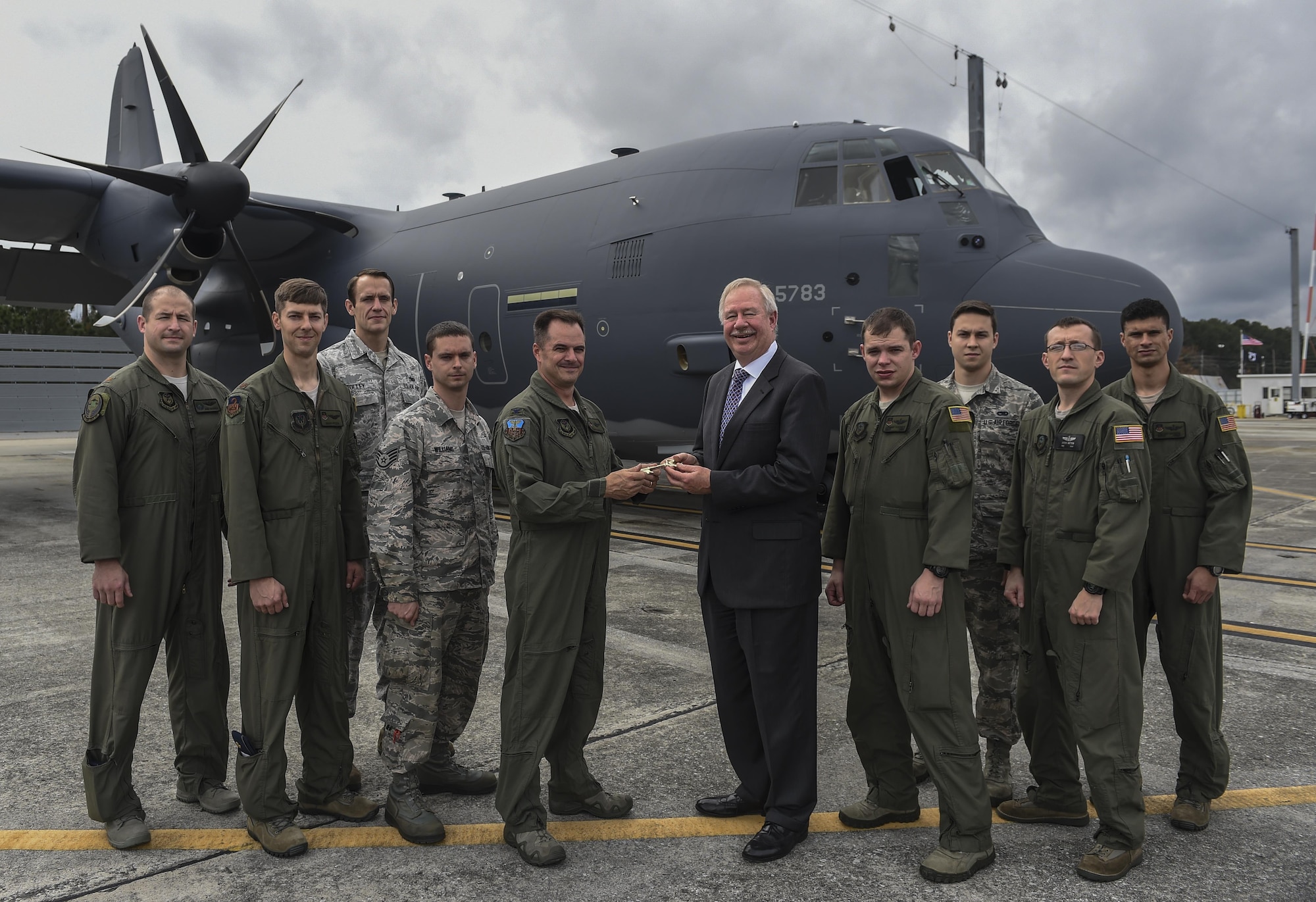 Col. Sean Farrell, commander of the 1st Special Operations Wing, receives a commemorative key to the MC-130J Commando II from Ray Fajay, director of air mobility business development at Lockheed Martin, at Lockheed Martin in Marietta, Ga., Dec. 11, 2015. The MC-130J will undergo modifications to become an AC-130J Ghostrider, which will provide the 1 SOW with close air support and air interdiction capabilities. (U.S. Air Force photo by Senior Airman Ryan Conroy)