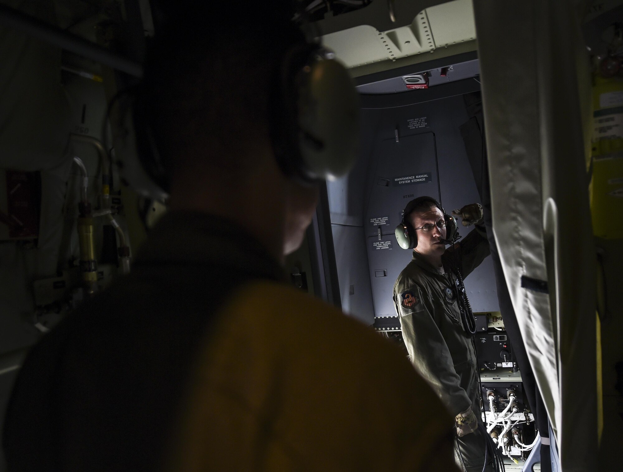 Staff Sgts. Oscar Garcia and Derek Watson, special mission aviators with the 1st Special Operations Group Detachment 2, communicate during preflight checks of an MC-130J Combat Talon II at Lockheed Martin in Marietta, Ga. Dec. 11, 2015. The MC-130J will undergo modifications to become an AC-130J Ghostrider, which will provide the 1 SOW with close air support and air interdiction capabilities. (U.S. Air Force photo by Senior Airman Ryan Conroy)