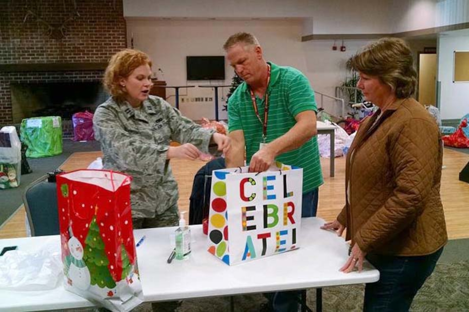 Defense Logistics Agency employees at Defense Supply Center Richmond, Virginia, made the holidays special for 112 local children Dec. 16, 2015 by providing gifts for four local schools’ Annual Angel Tree programs.  Here, DLA Aviation’s Air Force Capt. Kelly Dickerson, along with DLA Aviation employees John Pilkerton and Bonnie Jenkins collected and sorted gifts provided for G.H. Reid Elementary School in Richmond. 

