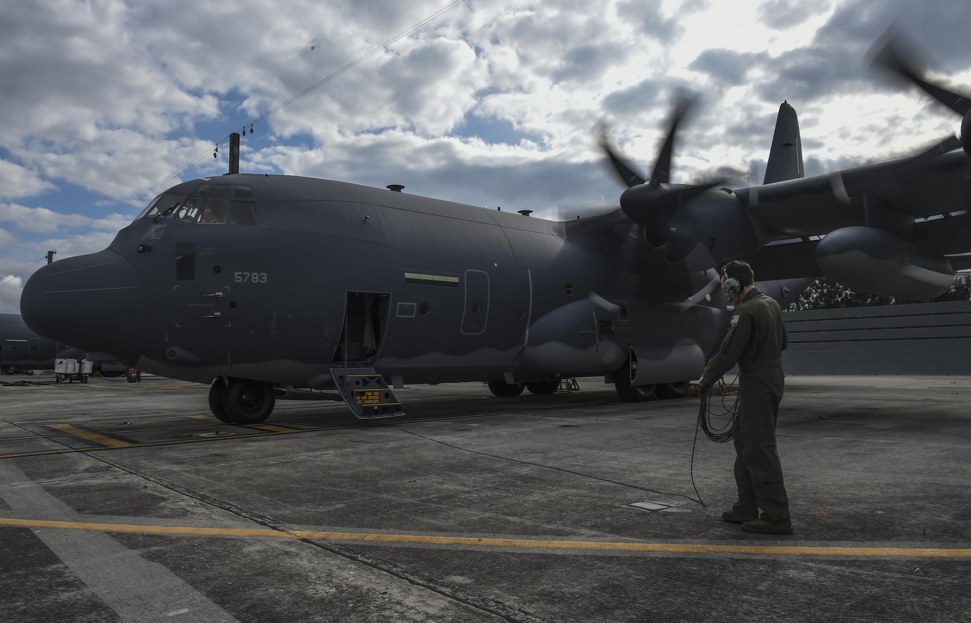 Staff Sgt. Derek Watson, a special missions aviator with the 1st Special Operations Group Detachment 2, maintains communications with pilots during a pre-flight check of an MC-130J Commando II at Lockheed Martin in Marietta, Ga., Dec. 11, 2015. The MC-130J will undergo modifications to become an AC-130J Ghostrider, which will provide the 1 SOW with close air support and air interdiction capabilities. (U.S. Air Force photo by Senior Airman Ryan Conroy)