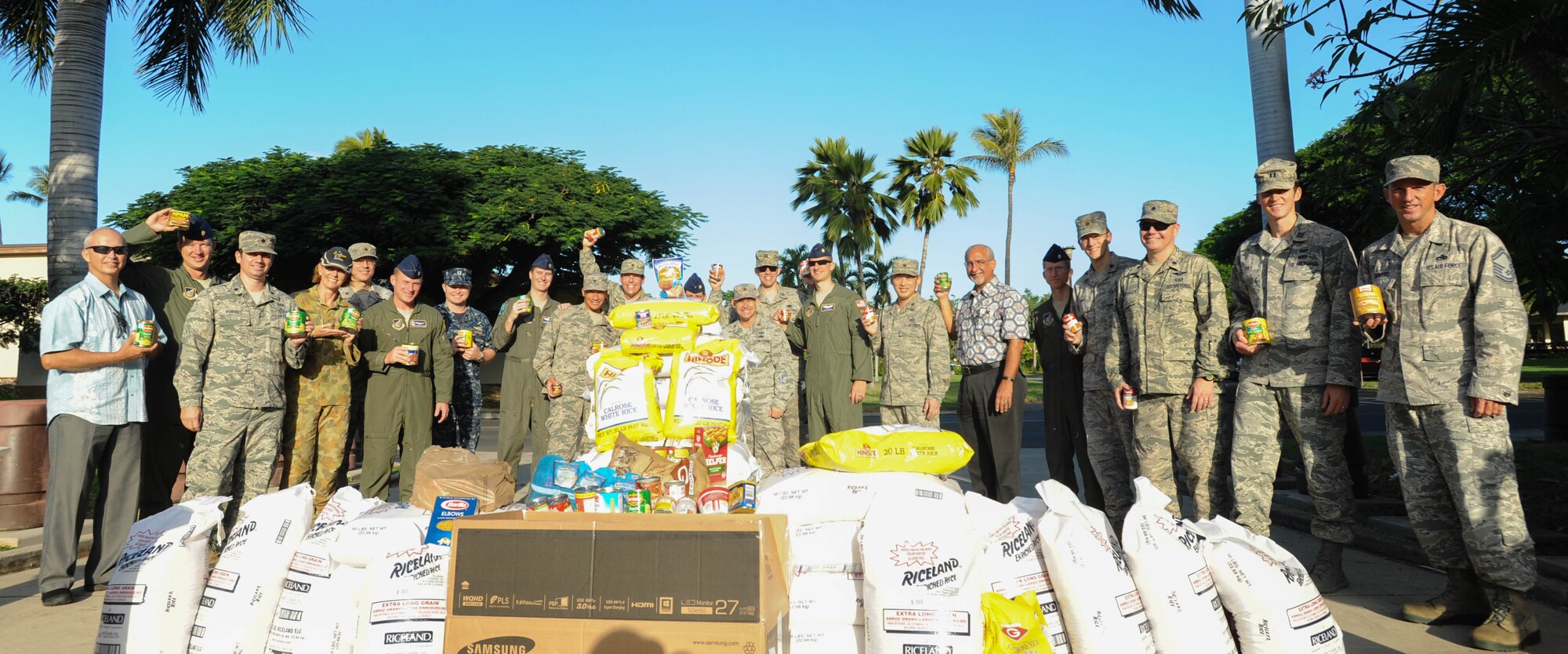Members from Pacific Air Forces A5/8 Directorate of Strategy, Plans and Programs donate food to a local Hawaii food bank, Dec. 15, 2015, Joint Base Pearl Harbor-Hickam, Hawaii. The Airmen collected and donated more than 2,500 pounds of food, to include rice and canned goods. (U.S. Air Force photo by Tech. Sgt. Amanda Dick/Released)