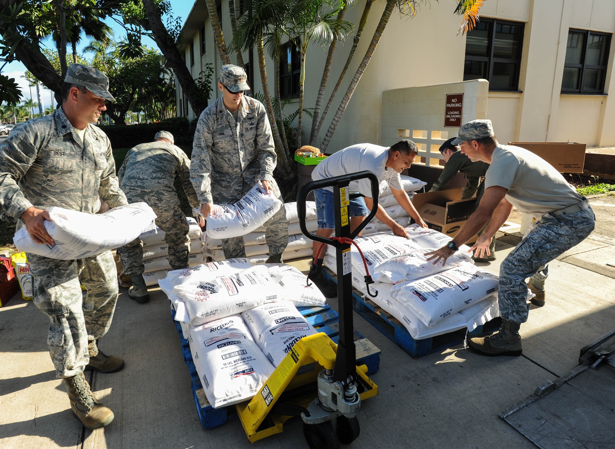 Members from Pacific Air Forces A5/8 Directorate of Strategy, Plans and Programs donate food to a local Hawaii food bank, Dec. 15, 2015, Joint Base Pearl Harbor-Hickam, Hawaii. The Airmen collected and donated more than 2,500 pounds of food, to include rice and canned goods. (U.S. Air Force photo by Tech. Sgt. Amanda Dick/Released)
