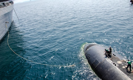 150514-N-ZZ999-094 
PHUKET, Thailand (May 14, 2015) Sailors aboard the Los Angeles-class attack submarine USS Key West (SSN 722) heave in a mooring line as the submarine tender USS Emory S. Land (AS 39) prepares to moor Key West alongside during Guardian Sea 2015, an annual exercise with the Royal Thai Navy. Emory S. Land is a forward deployed expeditionary submarine tender on an extended deployment conducting coordinated tended moorings and afloat maintenance in the U.S. 5th and 7th Fleet areas of responsibility. (U.S. Navy photo by Mass Communication Specialist Seaman Apprentice Michael Doan/Released)                                                                                                                                                                                                                                                                     