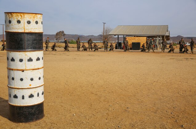 Recruits of Fox Company, 2nd Recruit Training Battalion, sight in on a barrel painted with targets during Grass Week at Edson Range, Weapons and Field Training Battalion, Marine Corps Base Camp Pendleton, Calif., Dec. 9. The barrels have targets painted on them simulating what they will see from the 200, 300 and 500-yard line. Today, all males recruited from west of the Mississippi are trained at MCRD San Diego. The depot is responsible for training more than 16,000 recruits annually. Fox Company is scheduled to graduate Jan. 29.