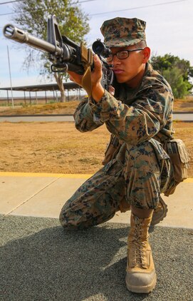 Recruit Thanh T. Truong, Fox Company, 2nd Recruit Training Battalion, practices the kneeling position during Grass Week at Edson Range, Weapons and Field Training Battalion, Marine Corps Base Camp Pendleton, Calif., Dec. 9. Recruits also learned the standing, sitting and prone shooting positions, and they were given the entire week to master them. Today, all males recruited from west of the Mississippi are trained at MCRD San Diego. The depot is responsible for training more than 16,000 recruits annually. Fox Company is scheduled to graduate Jan. 29.