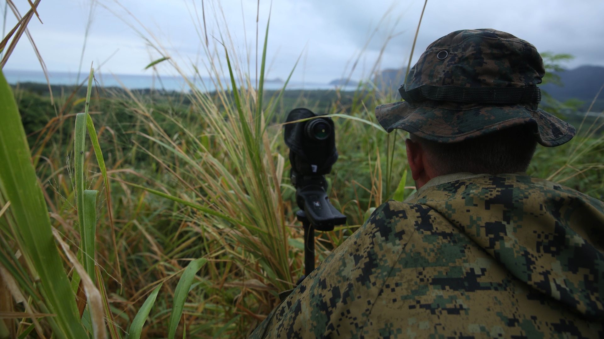 Lance Cpl. Mark Toub Jr., from Boyertown, Pa., and pointman with Company A, 1st Reconnaissance Battalion, 1st Marine Division, surveys a named area of interest during reconnaissance and surveillance training, Nov. 19-21, 2015, aboard Marine Corps Training Area Bellows, Hawaii. The Marines conducted insertion, infiltration, execution, exfiltration, and extraction in terrain unfamiliar to what is usually found at their home base in California. The Hawaiian terrain ranged from beach shores, to dense jungle and open valleys during pouring rains. 