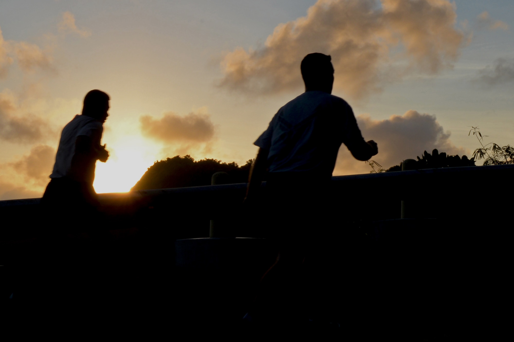 Two Airmen run up Sanders Slope during the Santa Shuffle Dec. 16 2015, at Andersen Air Force Base, Guam. Runners had two routes to choose from during the Santa Shuffle - a 5K along Tarague Beach or a 4.8 mile run up Sanders Slope. (U.S. Air Force photo/ Airman 1st Class Jacob Skovo)
