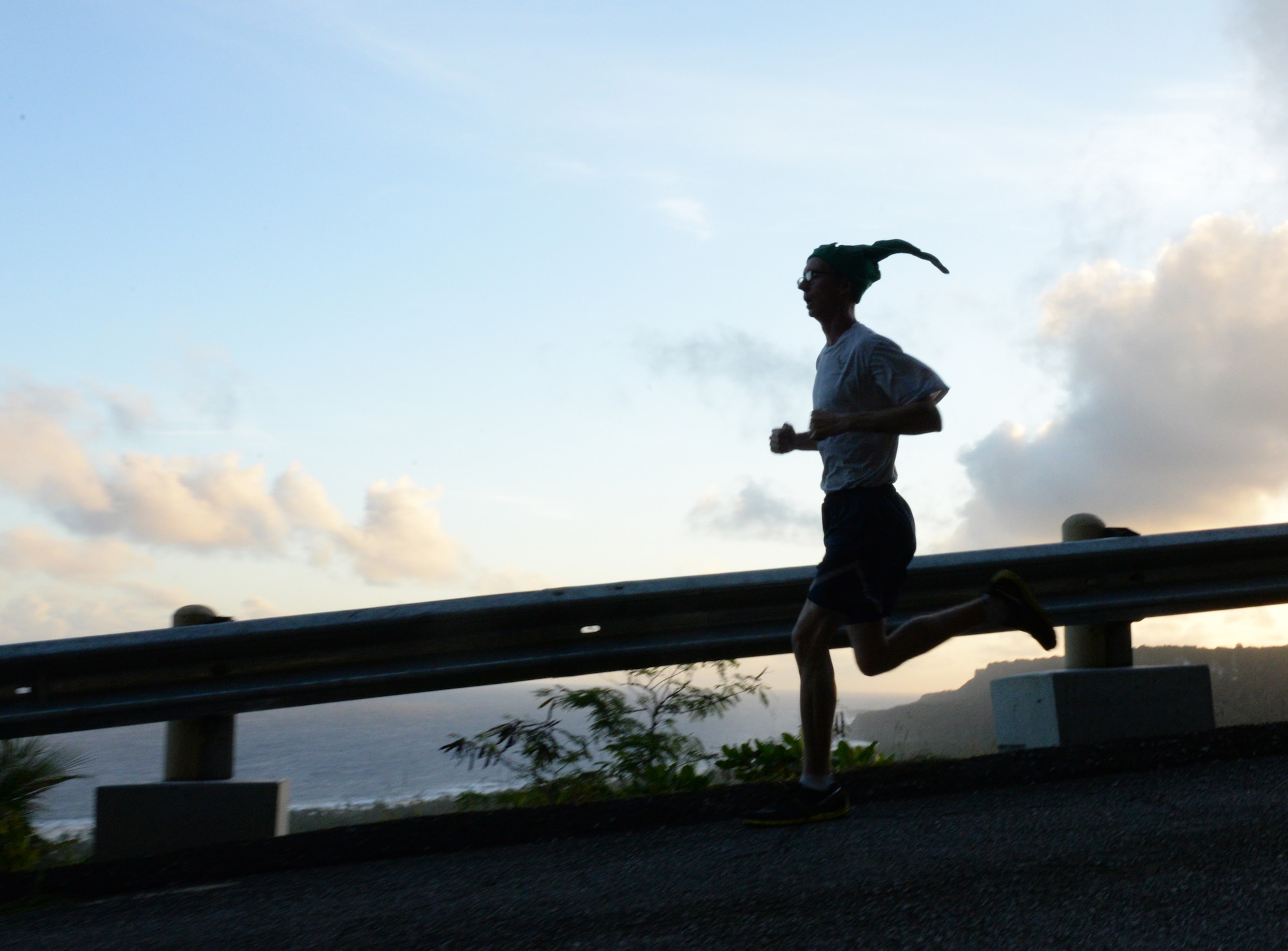 An Airman runs downhill during the Saunders Slope Santa Shuffle Dec. 16 2015, at Andersen Air Force Base, Guam.  Coral Reef Fitness Center hosts a run every month to encourage fitness amongst Team Andersen. (U.S. Air Force photo/ Airman 1st Class Jacob Skovo)