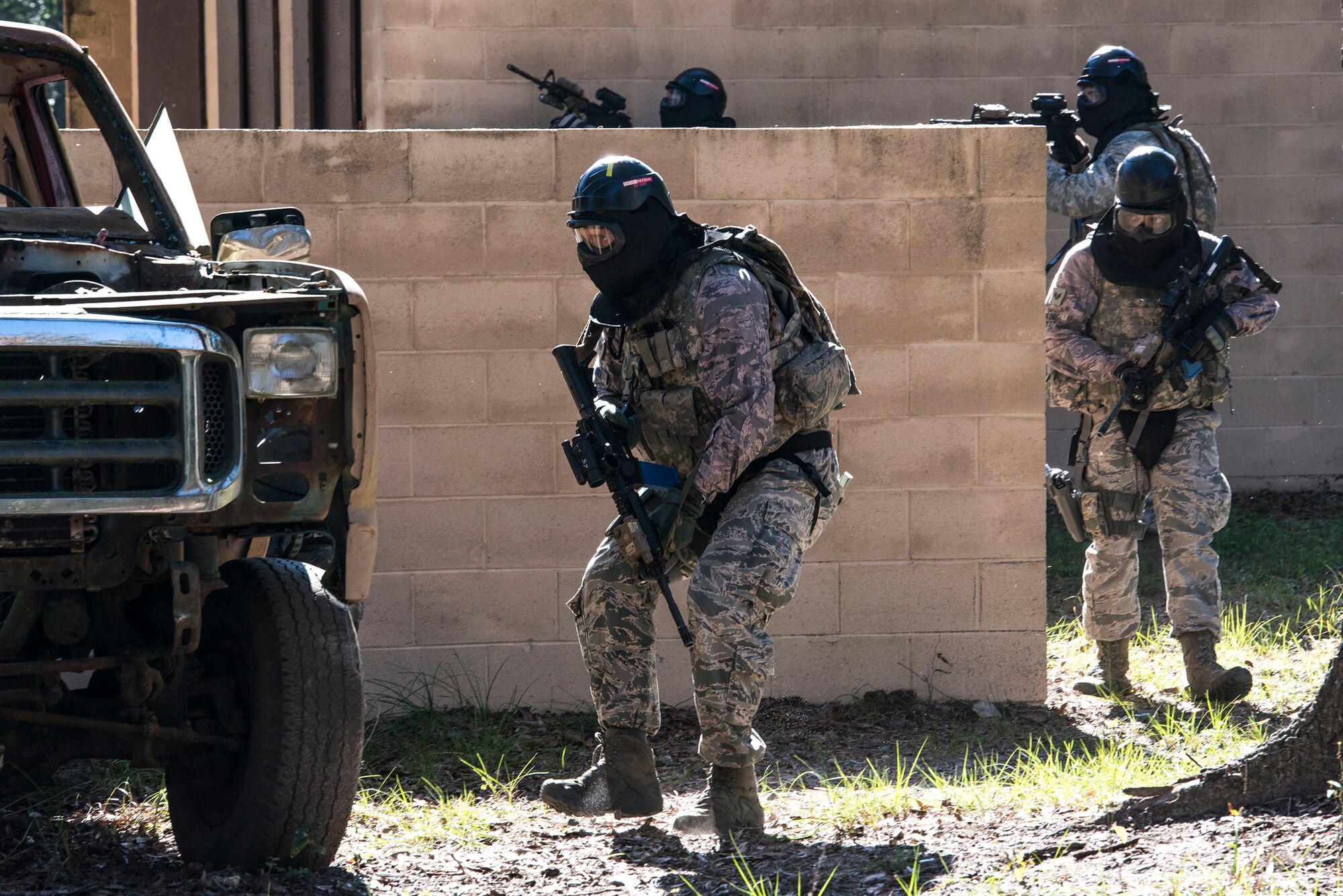 Airmen from the 822d Base Defense Squadron provide cover while teammates advance toward their target during force-on-force training, Dec. 10, 2015, at Moody Air Force Base, Ga. The Airmen’s goal while completing the mission was to strategize as a team. (U.S. Air Force photo by Airman 1st Class Lauren M. Johnson/Released)