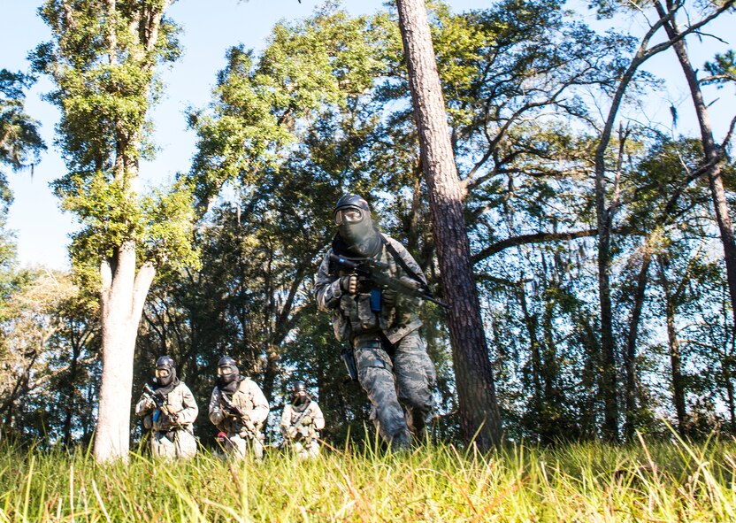 Airmen from the 822d Base Defense Squadron run for cover during force-on- force training, Dec. 10, 2015, at Moody Air Force Base, Ga. During the training, the team’s goal was to rescue a simulated casualty while defeating enemy forces. (U.S. Air Force photo by Airman 1st Class Lauren M. Johnson/Released)
