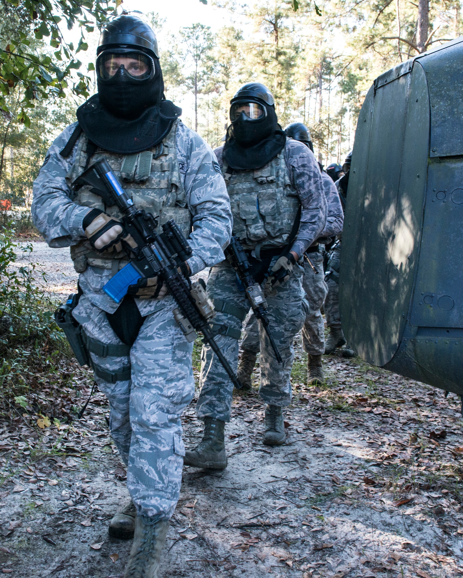 Airmen from the 822d Base Defense Squadron walk through the military operations in urban terrain village training facility during force-on-force training, Dec. 10, 2015, at Moody Air Force Base, Ga. Teams located and rescued a simulated casualty while engaging opposing forces. (U.S. Air Force photo by Airman 1st Class Lauren M. Johnson/Released)