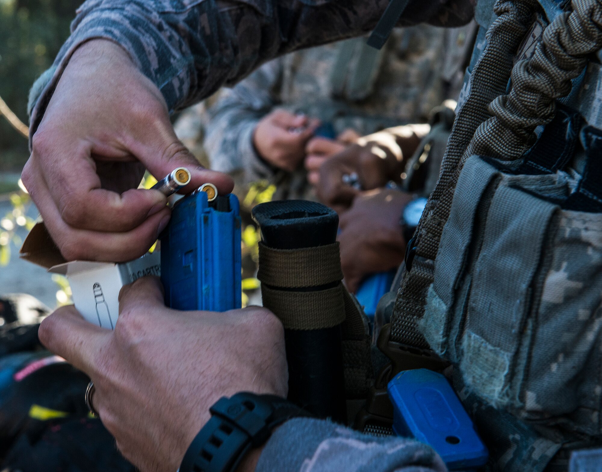 Airmen from the 822d Base Defense Squadron load simulation rounds into their M4 carbine rifles during force-on-force training, Dec. 10, 2015, at Moody Air Force Base, Ga. Airmen used simulation rounds to ensure realistic training without causing serious harm to participants. (U.S. Air Force photo by Airman 1st Class Lauren M. Johnson/Released)