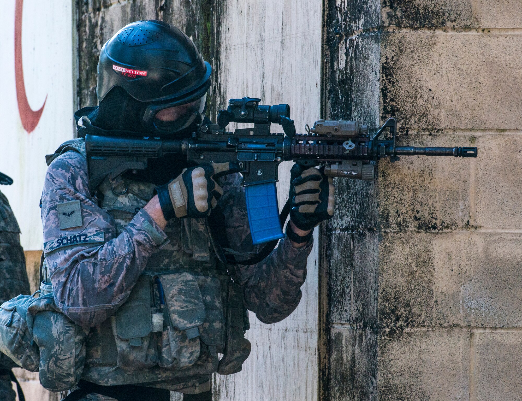 U.S. Air Force Airman 1st Class Cody Schatz, 822d Base Defense Squadron fire team member, aims at the enemy during force-on-force training, Dec. 10, 2015, at Moody Air Force Base, Ga. Airmen used simulated rounds in M9 Beretta pistols and M4 Carbine rifles during the quarterly exercise. (U.S. Air Force photo by Airman 1st Class Lauren M. Johnson/Released)