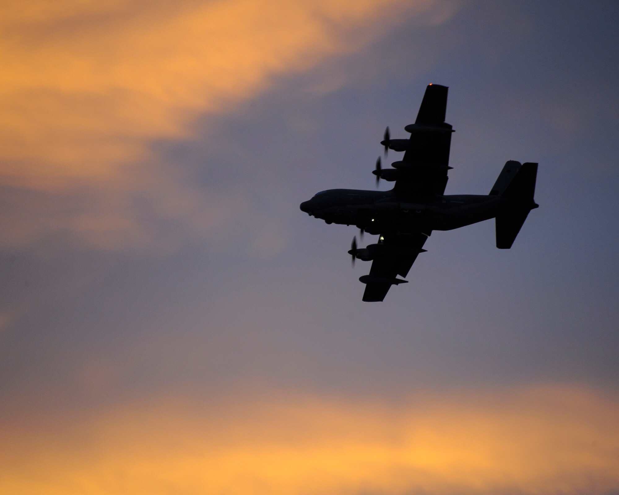 A U.S. Air Force HC-130J Combat King II from the 79th Rescue Squadron flies over Fort Huachuca, Ariz., during aerial delivery and recovery training with the 563rd Operations Support Squadron Dec. 9, 2015.  The HC-130J, from Davis-Monthan Air Force Base, airdropped a Humvee and a 3,500-pound heavy equipment training platform during the training. (U.S. Air Force photo by Senior Airman Chris Massey/Released)