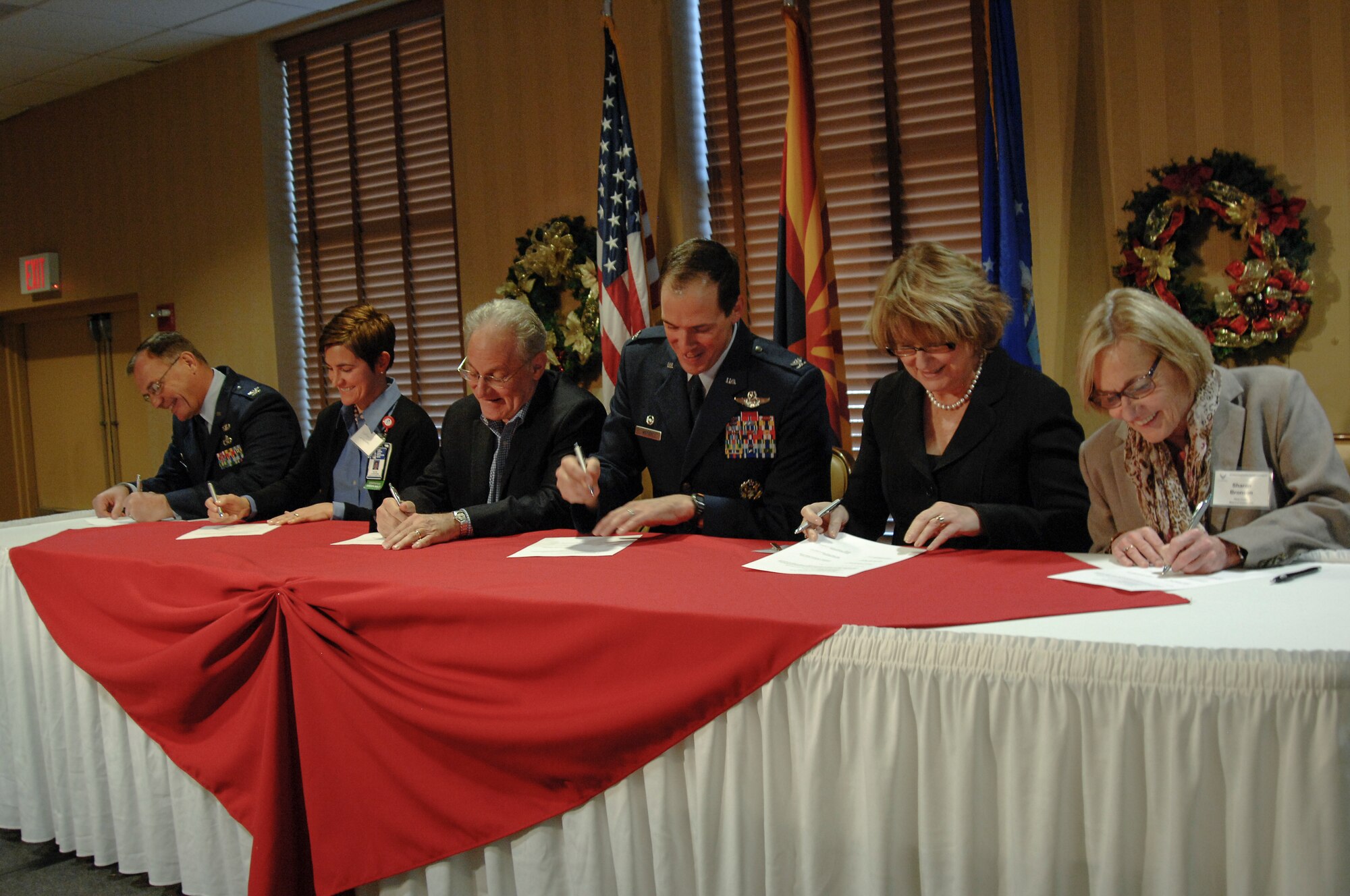 Left to right U.S Air Force Col. Rodger Schuld, 355th Mission Support Group commander, Katie Landwehr, Southern Arizona Veteran’s Affairs Healthcare System assistant director, Mayor Jonathan Rothschild, the City of Tucson, Col. James Meger, 355th Fighter Wing commander, Ann Weaver Hart, University of Arizona president, Sharon Bronson, Pima County Board of Supervisors chairperson, sign the steering committee memorandum of understanding at Davis-Monthan Air Force Base, Ariz., Dec. 14, 2015. The 355th FW and 55th Electronic Combat Group leadership signed four agreements with local officials to increase the collaboration between the base and the local community. (U.S. Air Force photo by Staff Sgt. Angela Ruiz/Released)