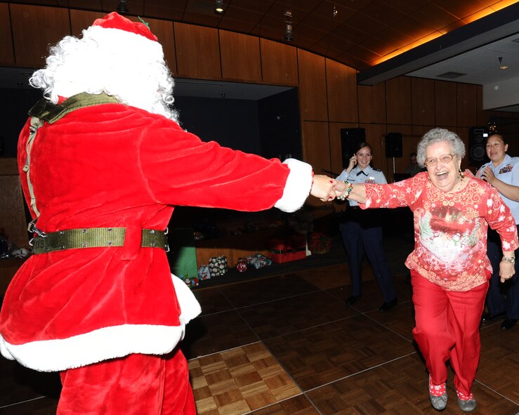 A member of the Sims State Veterans Home swing dances with Santa Claus during the Golden Age Holiday party Dec. 15 at the Horizons Community Center. More than 150 veterans were in attendance to this annual event. (U.S. Air Force photo by Senior Airman Ty-Rico Lea/Released)