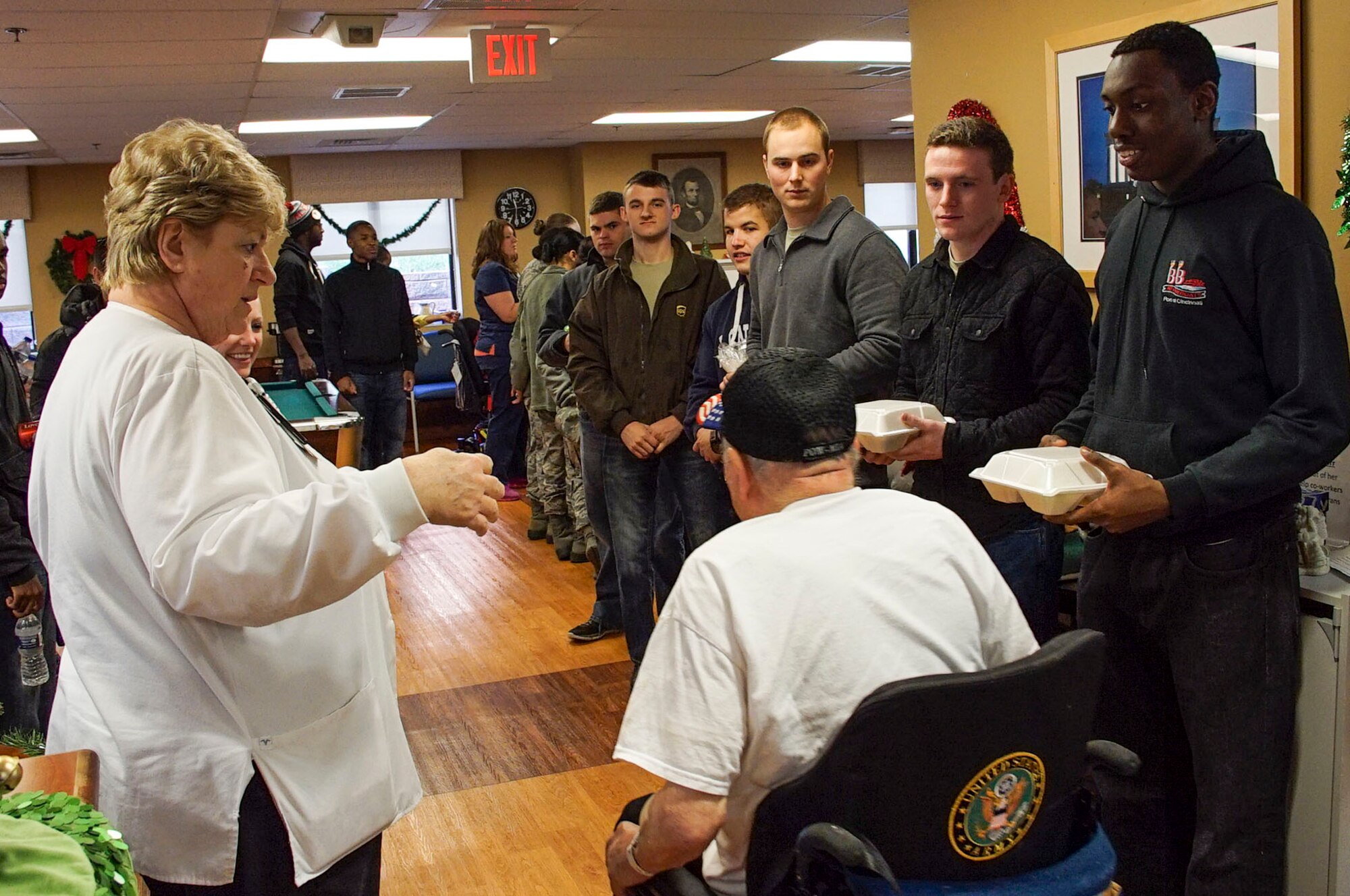 DAYTON, Ohio - A resident of Lakeside Manor is greeted by volunteers from the 445th Airlift Wing as they bring prepared lunches to residents of the Dayton Veterans Affairs Medical Center, Dayton, Ohio during the annual Dayton VA's annual holiday party Dec. 5, 2015. (U.S. Air Force photo/Senior Airman Devin Long)
