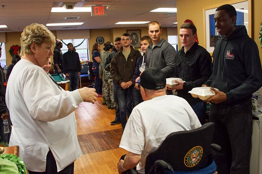 DAYTON, Ohio - A resident of Lakeside Manor is greeted by volunteers from the 445th Airlift Wing as they bring prepared lunches to residents of the Dayton Veterans Affairs Medical Center, Dayton, Ohio during the annual Dayton VA's annual holiday party Dec. 5, 2015. (U.S. Air Force photo/Senior Airman Devin Long)
