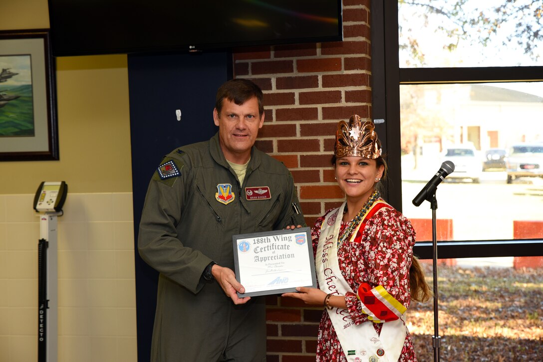 Ja-Li-Si Pittman, 2015-2016 Miss Cherokee, receives a certificate of appreciation from Col. Brian Burger, 188th Operations Group commander, at Ebbing Air National Guard Base, Fort Smith, Ark., for her participation in the 188th Wing’s Native American Indian Heritage Month celebration Nov. 18, 2015. Pittman is currently the vice-president of the Cherokee Nation Tribal Youth Council and her platform has tackled youth needing strong mentors in school. (U.S. Air National Guard photo by Senior Airman Cody Martin/Released)