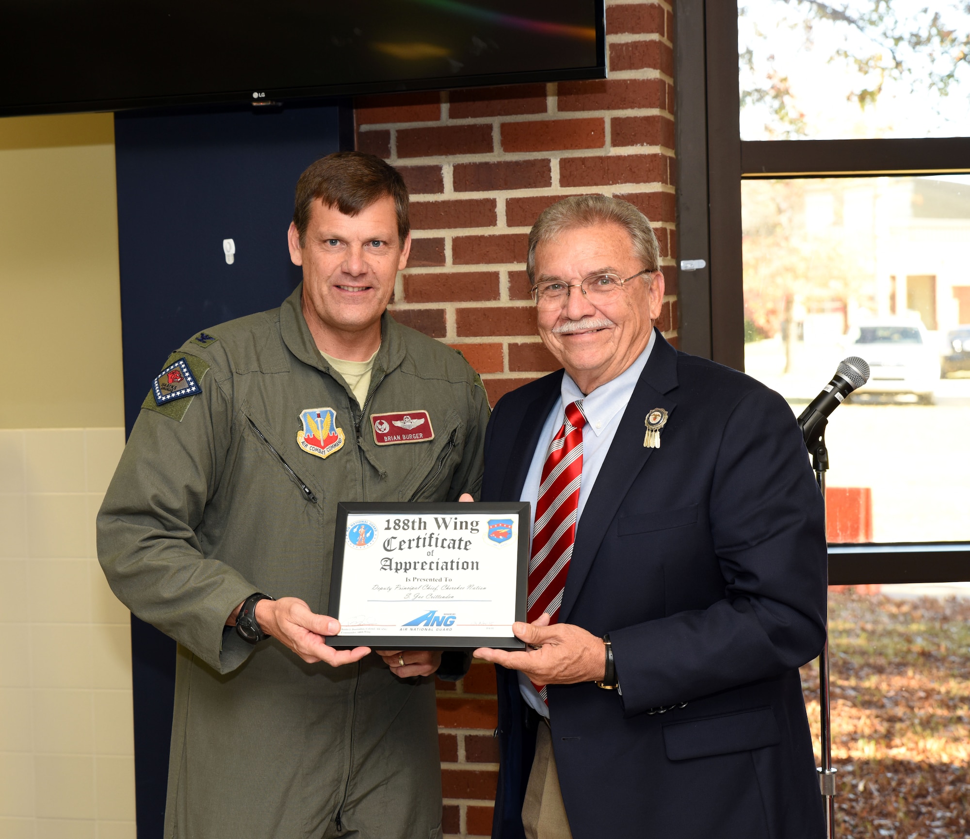 Joe Crittenden, deputy principal chief of the Cherokee Nation, receives a certificate of appreciation from Col. Brian Burger, 188th Operations Group commander, at Ebbing Air National Guard Base, Fort Smith, Ark., for his participation in the 188th Wing’s Native American Indian Heritage Month celebration Nov. 18, 2015. Crittenden served two terms as a Cherokee Nation council member and was elected as deputy principal chief in 2011. (U.S. Air National Guard photo by Senior Airman Cody Martin/Released)
