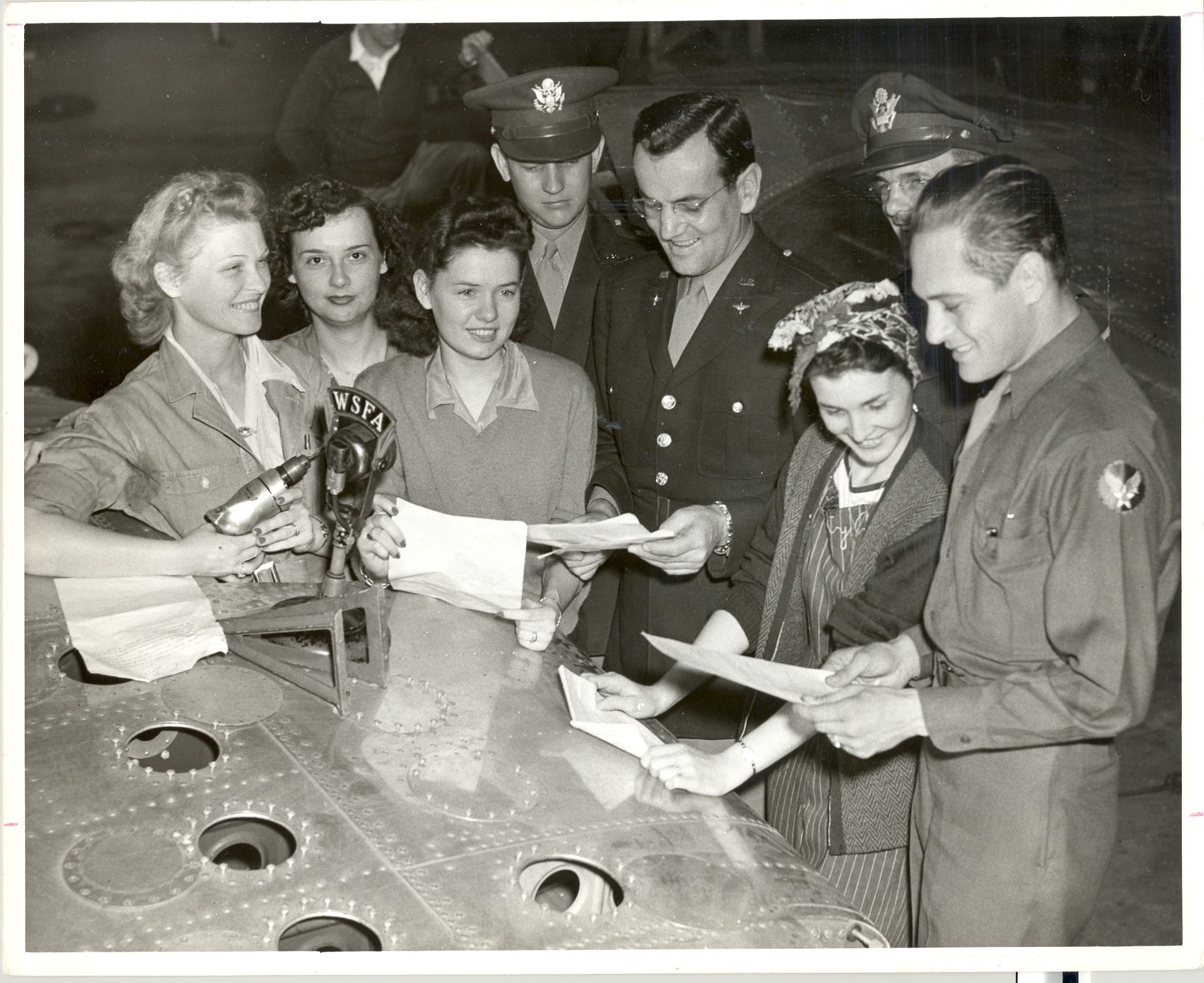 Captain Glenn Miller is speaking with female riveters on Max Field, Alabama, 1942.