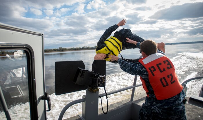 A Sailor from the harbor patrol unit simulates a man-overboard exercise Dec. 9, 2015, on the Cooper River near Joint Base Charleston – Weapons Station, S.C. JB Charleston’s port operations recently implemented a new training program to effectively cut down on spending and improve resourcefulness. The training consisted of putting Sailors through a series of classes. The week following their classes, the new trainers were put to the test instructing the newer Sailors on the information they just learned. (U.S. Air Force photo/Senior Airman Clayton Cupit)