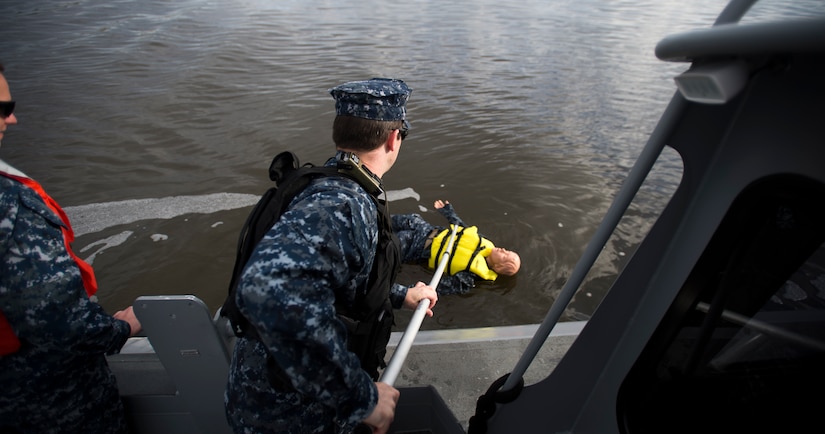 Sailors from the harbor patrol unit simulate a man-overboard exercise Dec. 9, 2015, on the Cooper River near Joint Base Charleston – Weapons Station, S.C. JB Charleston’s port operations recently implemented a new training program to effectively cut down on spending and improve resourcefulness. The training consisted of putting Sailors through a series of classes. The week following their classes, they were put to the test instructing the newer Sailors on the information they just learned. (U.S. Air Force photo/Senior Airman Clayton Cupit)