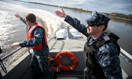 Sailors from the harbor patrol unit simulate a man-overboard exercise Dec. 9, 2015, on the Cooper River near Joint Base Charleston – Weapons Station, S.C. JB Charleston’s port operations recently implemented a new training program to effectively cut down on spending and improve resourcefulness. The training consisted of putting Sailors through a series of classes. The week following their classes, they were put to the test instructing the newer Sailors on the information they just learned. (U.S. Air Force photo/Senior Airman Clayton Cupit)