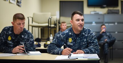 Sailors from Joint Base Charleston participate in a ‘Train the Trainer’ program Dec. 8, 2015, in a classroom at the security building on JB Charleston – Weapons Station, S.C. JB Charleston’s port operations has recently implemented a new training program to effectively cut down on spending and improve resourcefulness. The training consisted of putting the Sailors through a series of classes. The week following their classes, the new trainers were put to the test instructing newer Sailors on the information they just learned. (U.S. Air Force photo/Senior Airman Clayton Cupit)