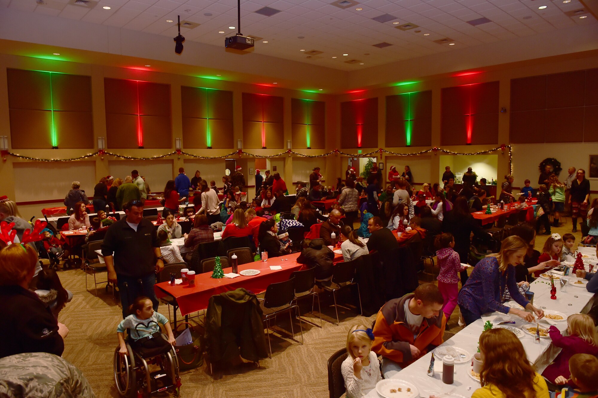 Team Buckley members enjoy the food and conversation during Breakfast with Santa at the Leadership Development Center Dec. 12, 2015, on Buckley Air Force Base, Colo. The event provided breakfast, a gift for each child and the opportunity for a picture with Santa Claus. (U.S. Air Force photo by Airman 1st Class Luke Nowakowski/Released)