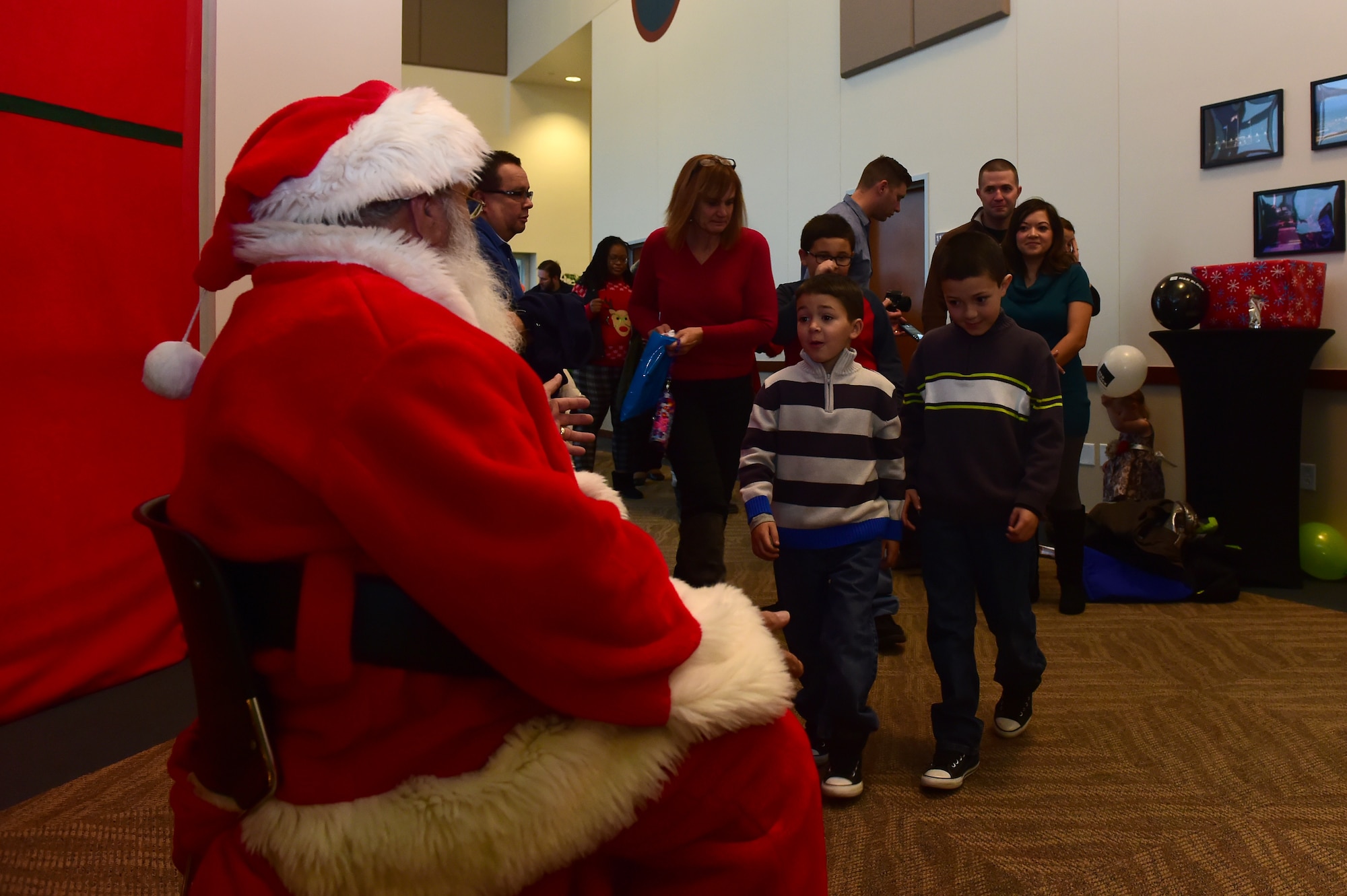 Team Buckley youth prepare to take a photo with Santa Claus during Breakfast with Santa at the Leadership Development Center Dec. 12, 2015, on Buckley Air Force Base, Colo. The event provided breakfast, a gift for each child and the opportunity for a picture with Santa Claus. (U.S. Air Force photo by Airman 1st Class Luke Nowakowski/Released)